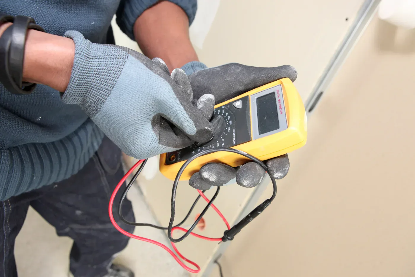 Électricien contrôlant un disjoncteur au tableau à Achères